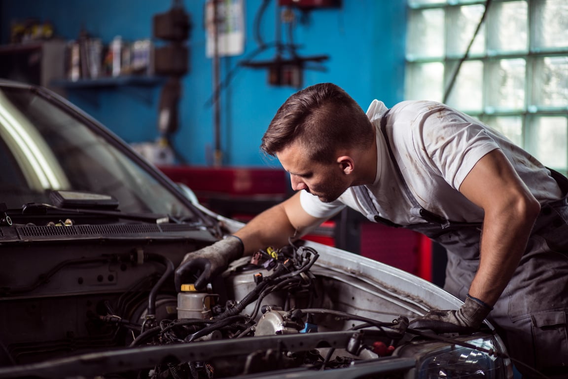 Car mechanic repairing vehicle